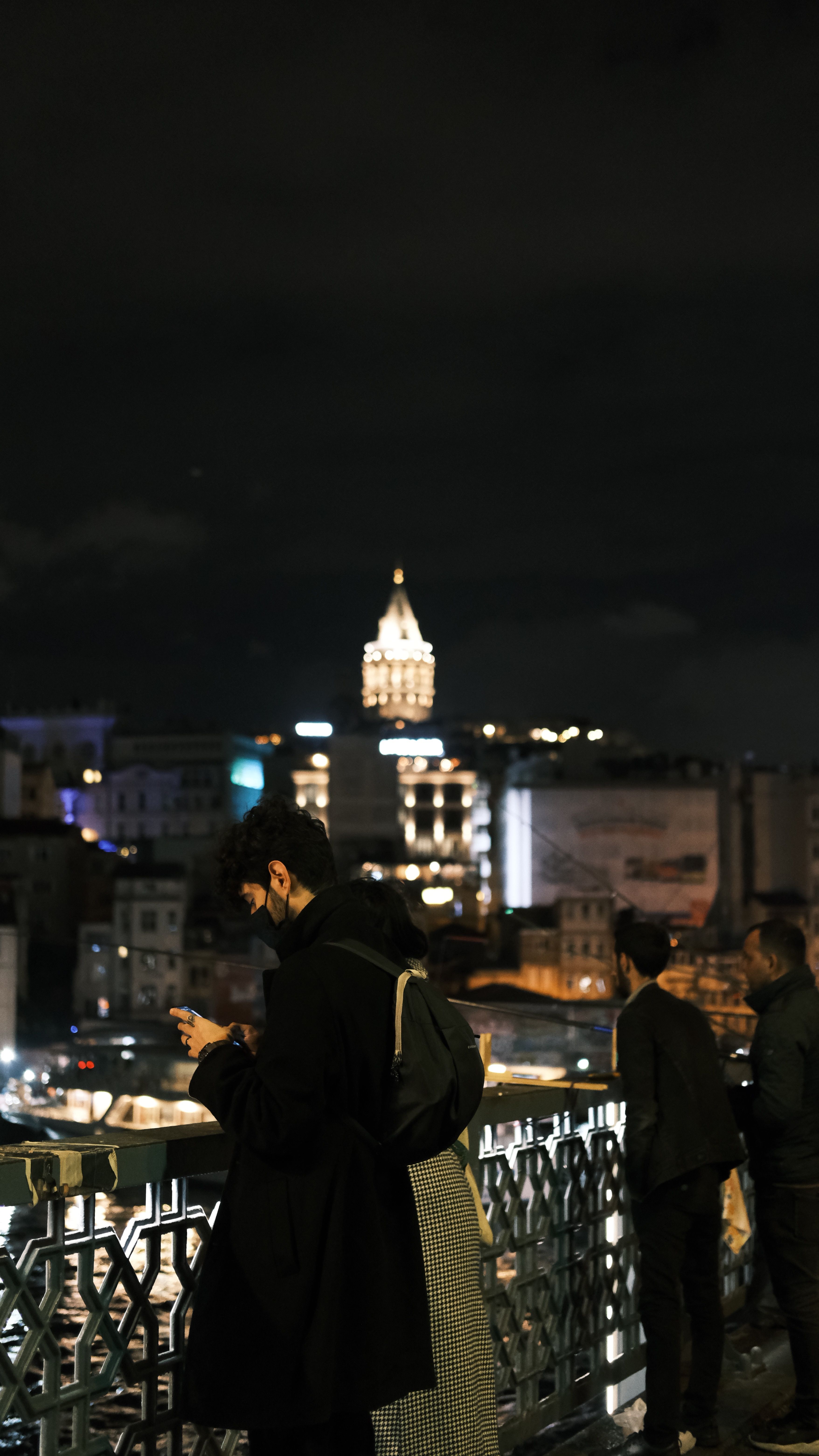 People Standing Near Concrete Bridge Railing During Night Time · Free ...