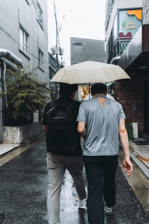 Men Walking While Raining
