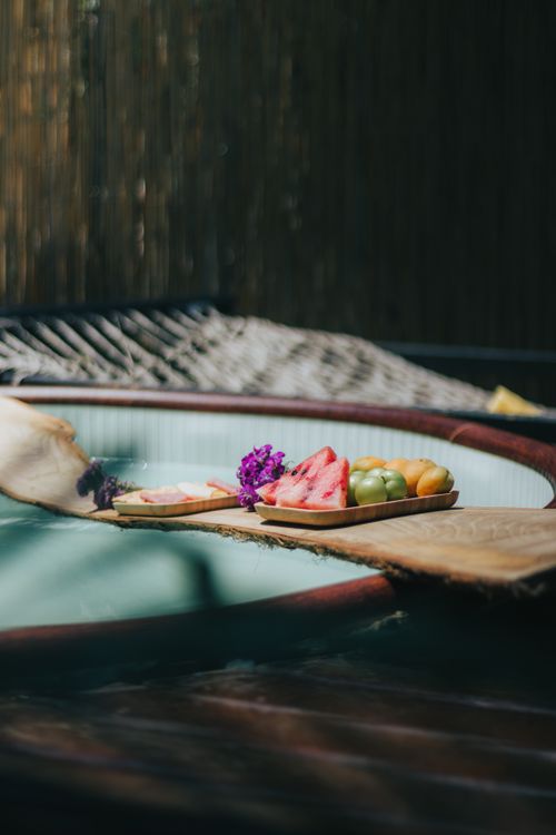 Free Luxurious spa setup with fresh fruits by the jacuzzi for a relaxing day. Stock Photo