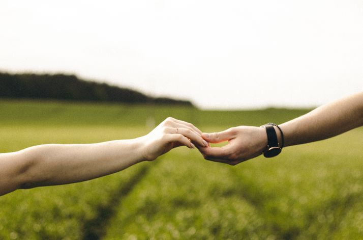 man and woman smiling together while using dating app