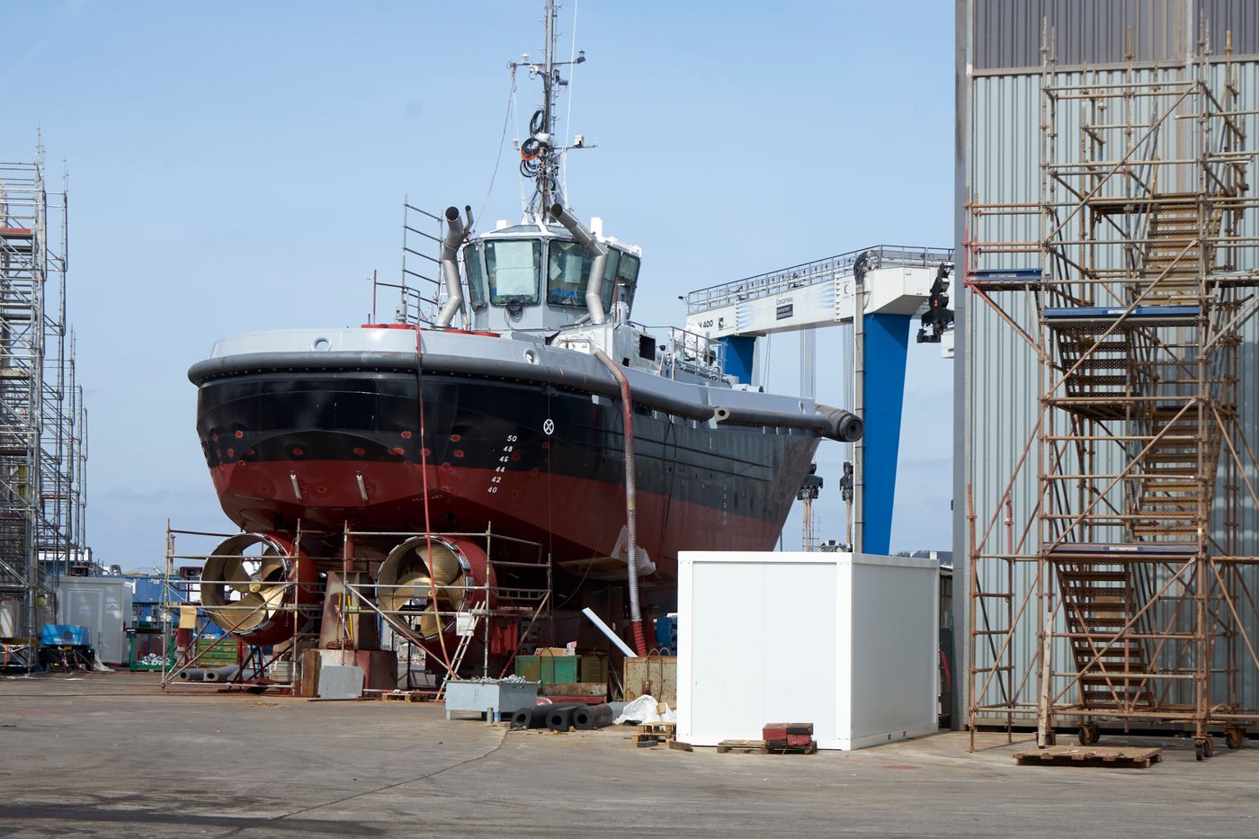 Large vessel undergoing repair work in a dockyard