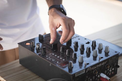 Free DJ Mixing Music on a Console Stock Photo