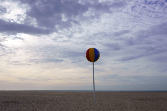 A striped beach ball against an evening sky — photo by Budget Bizar on Pexels