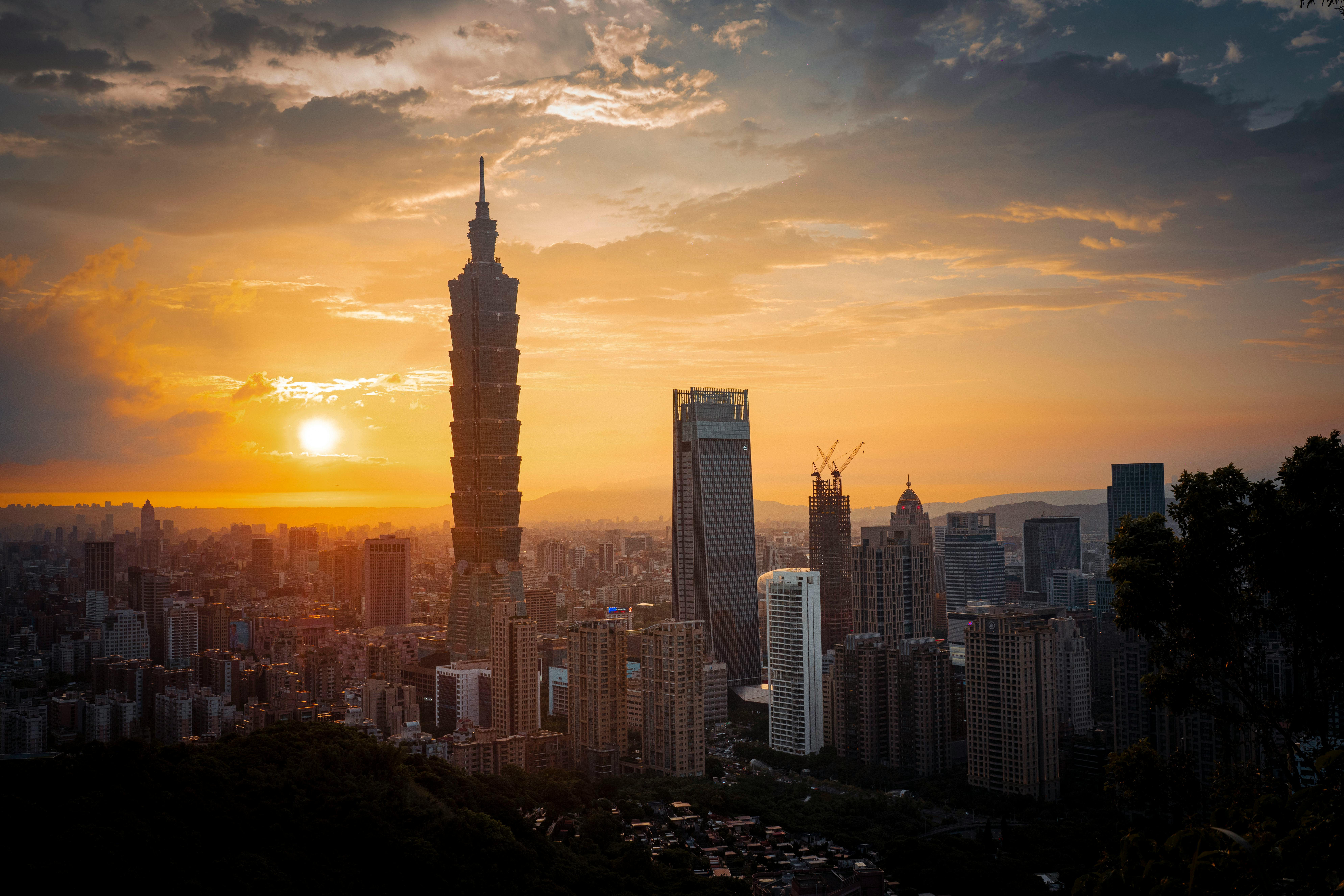 Captivating view of Taipei 101 and skyline with a vibrant sunset, showcasing urban architecture.