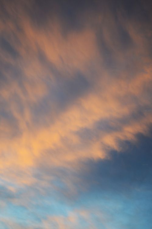 Free A stunning display of colorful clouds at sunset, creating a serene and atmospheric sky scene. Stock Photo