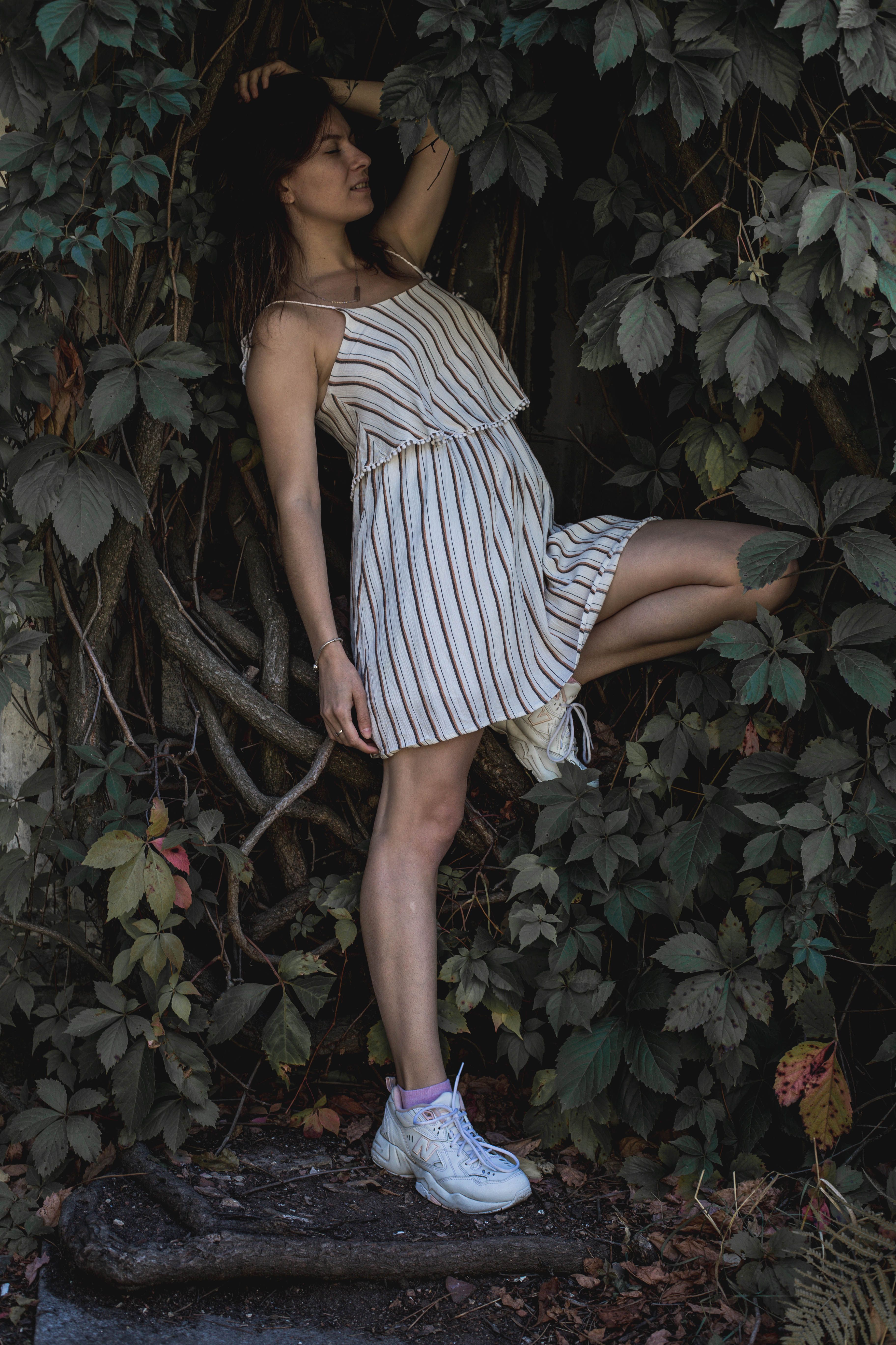 Woman in a Striped Top Posing with Her Hand on Her Head · Free Stock Photo