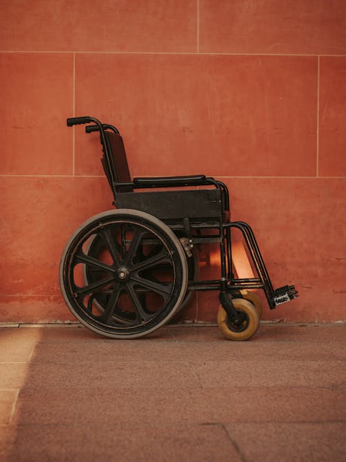 Free Wheelchair by Wall Stock Photo