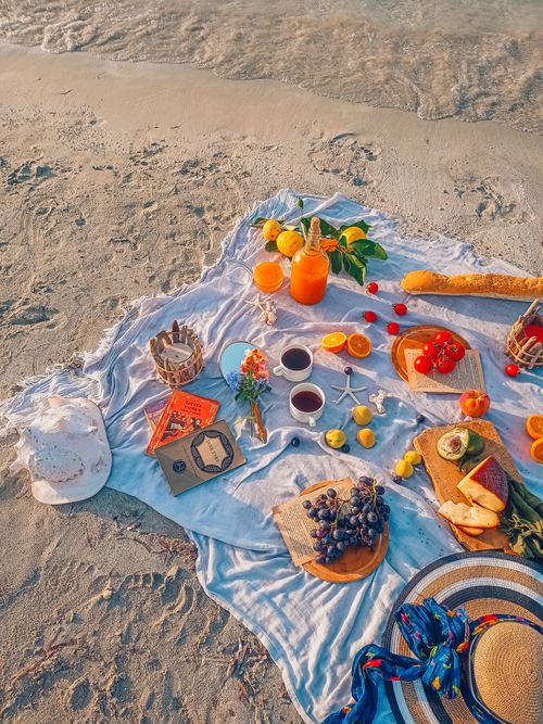 Free Vibrant picnic setup on Turkish beach featuring fruits, bread, and drinks. Perfect summer vibe. Stock Photo