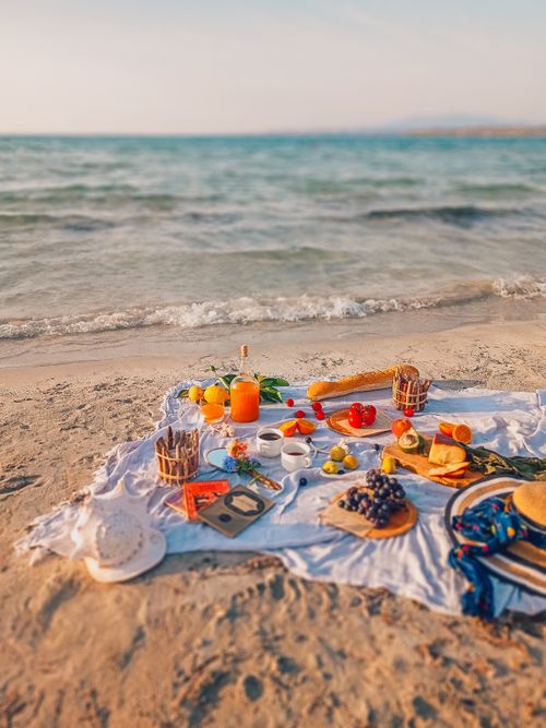 Free Summer picnic on a Turkish beach with fresh fruits and ocean waves. Stock Photo