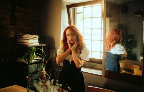Free Photograph of a Woman with Red Hair Posing with Her Hands on Her Face Stock Photo