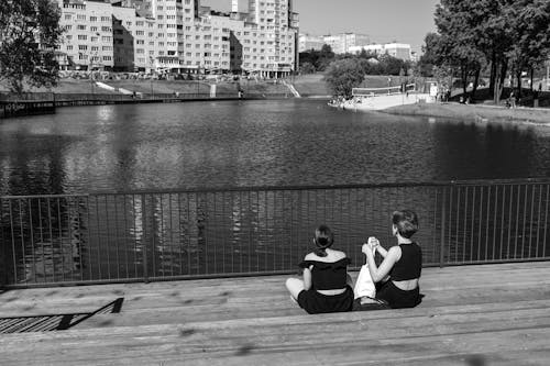 People Sitting Beside a Lake