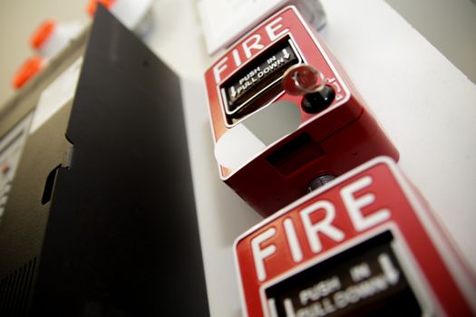 Fire alarm system attached to a white wall used for training