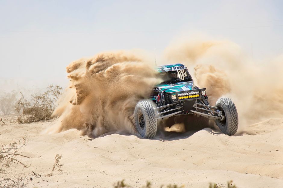 Dynamic off-road buggy racing through the sandy desert of Ensenada, Mexico.