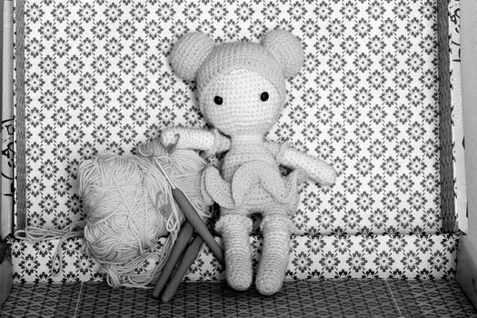White Bear Plush Toy on White and Black Floral Textile