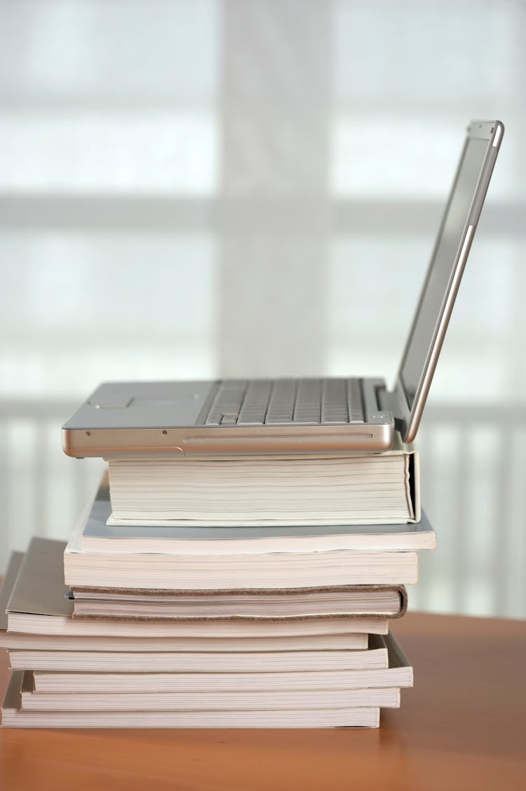  A Laptop On A Stack Of Books