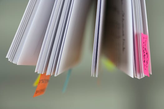 A close-up view of book pages with colorful sticky tabs, suggesting organization or study.