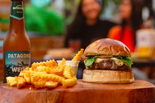 Burger With Fries on Brown Wooden Chopping Board