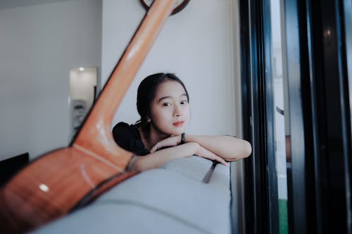 Free A Woman Sitting on the Couch Stock Photo