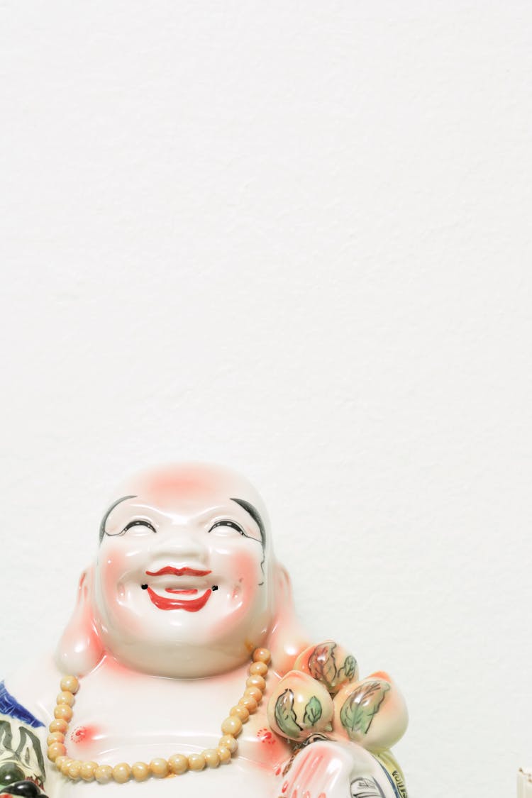 Ceramic Buddha Figurine On White Background