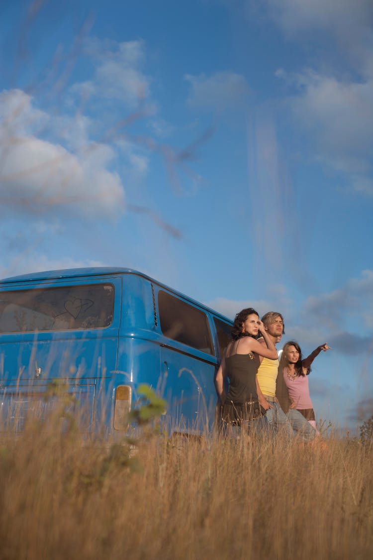 Man And Women Standing By Van