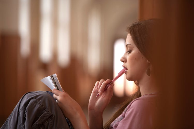 Photograph Of A Woman With A Pink Pen