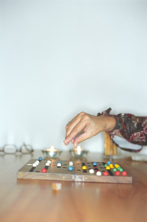 Hand of a Person Playing an Old-Fashioned Board Game