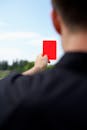 Over the Shoulder View of a Referee Showing the Red Card