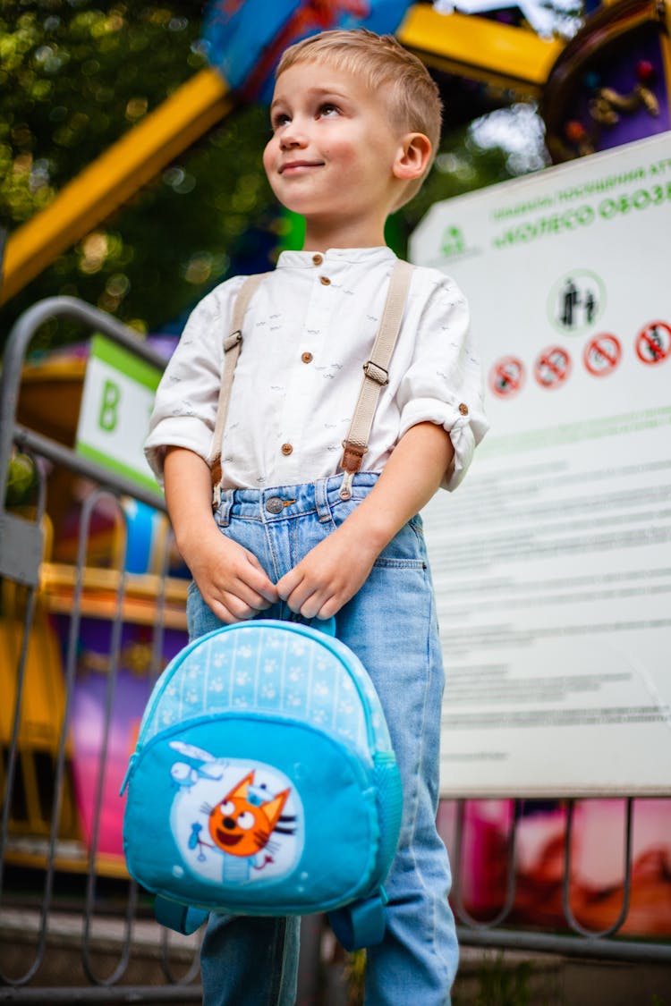 Boy Holding A Blue Bag