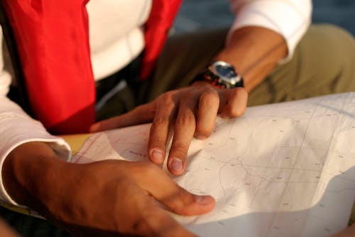 Man Holding and Pointing at a Map 