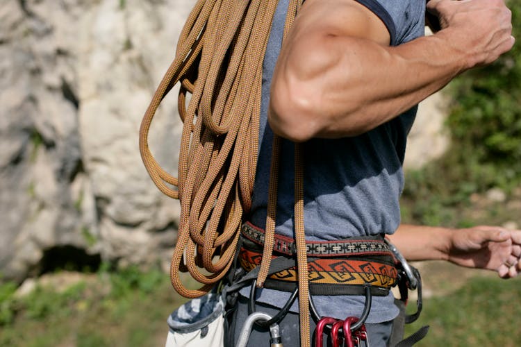 Close Up Of Man Carrying Ropes For Rock Climbing