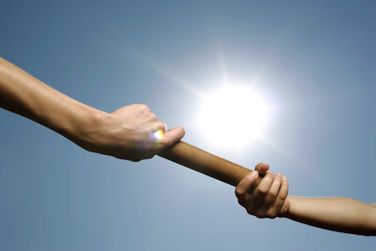 People Passing A Baton