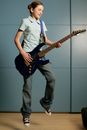 Man in White Button Up Shirt Playing Black Electric Guitar