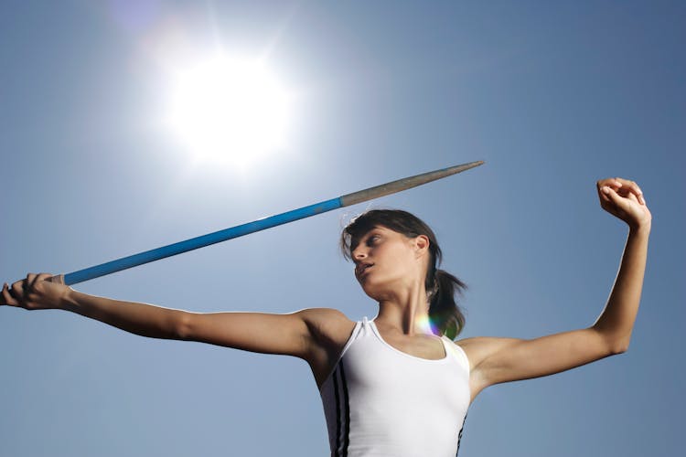 Sun Shining Over A Female Athlete Aiming A Javelin