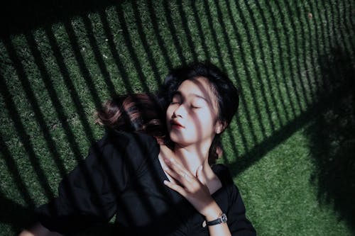 A Woman Lying on Green Grass