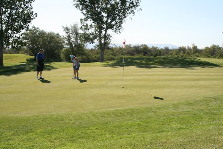 Man And Woman Playing Golf