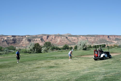 Photo of Man and Woman Playing Golf