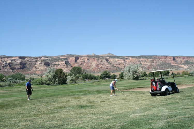 Photo Of Man And Woman Playing Golf