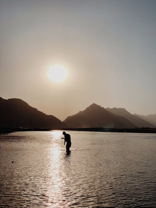 Silhouette of a Man on the River