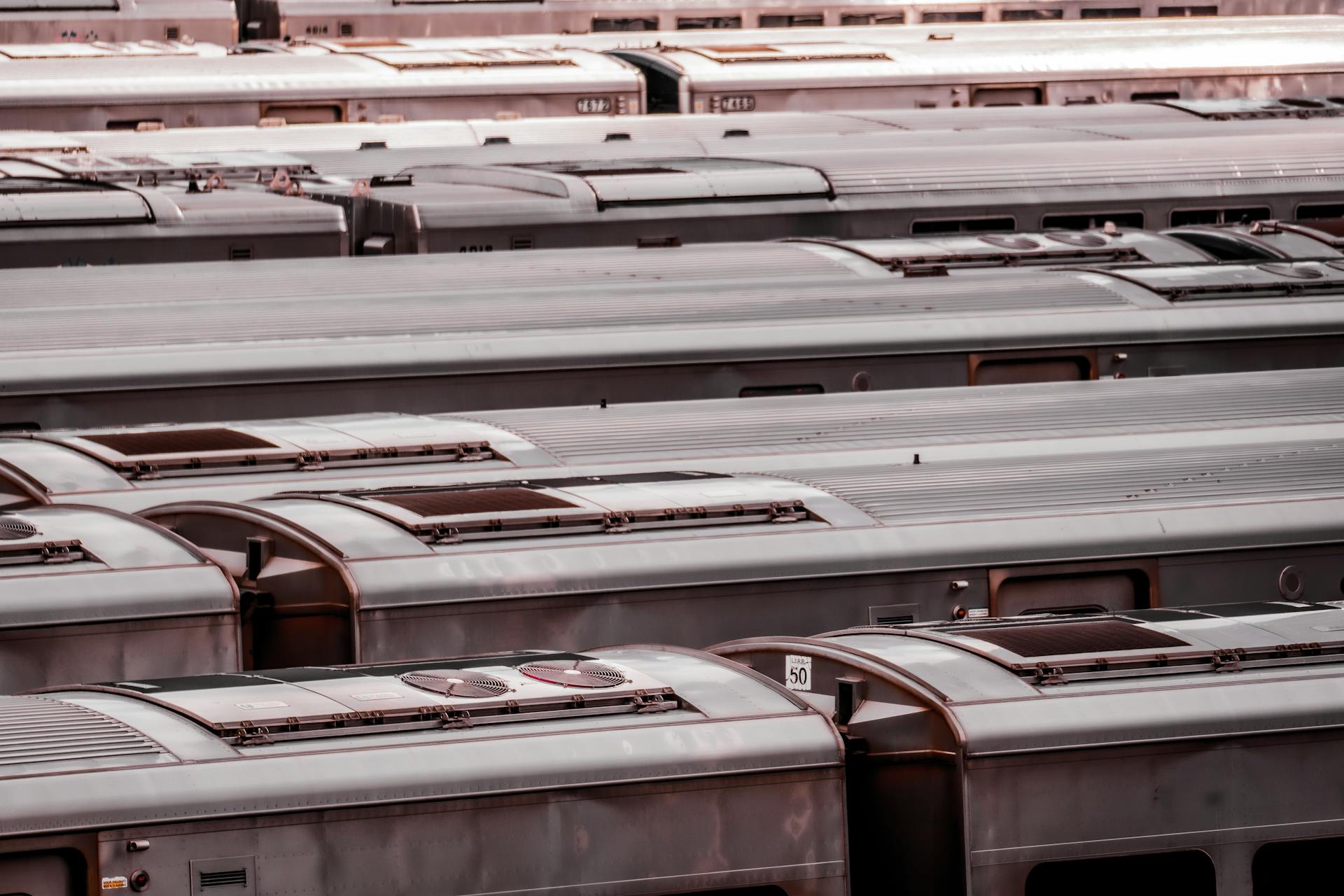 Aerial view of a row of train cars parked at a station in New York City.