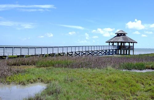 Free Wooden pier leading to a gazebo over wetlands under a clear blue sky in Port Lavaca, TX. Stock Photo