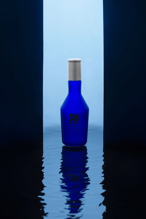 Free Blue Glass Bottle on Black Table Stock Photo