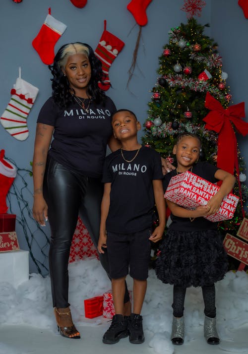 Woman and Children Standing near Christmas Tree