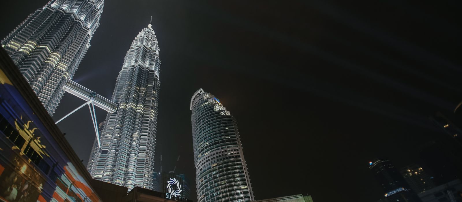 A stunning nighttime view of the Petronas Twin Towers illuminated in Kuala Lumpur, Malaysia. — flights from Doha to Kuala Lumpur