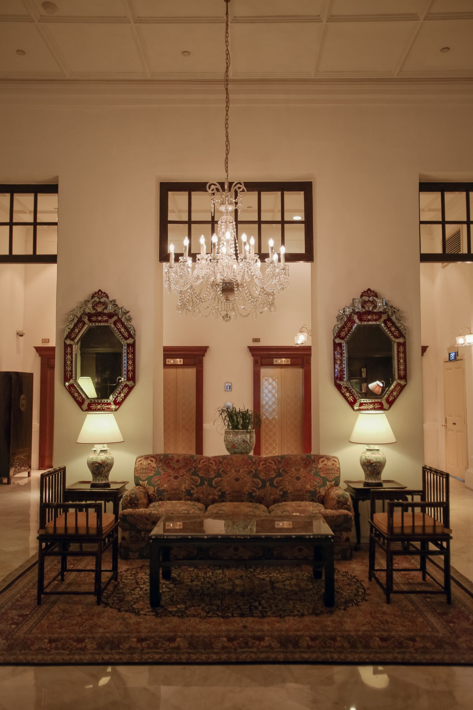 Royal rectangular center table under an ornate chandelier
