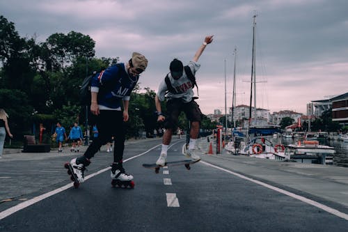 Man Skateboarding and Rollerskating on the Street 