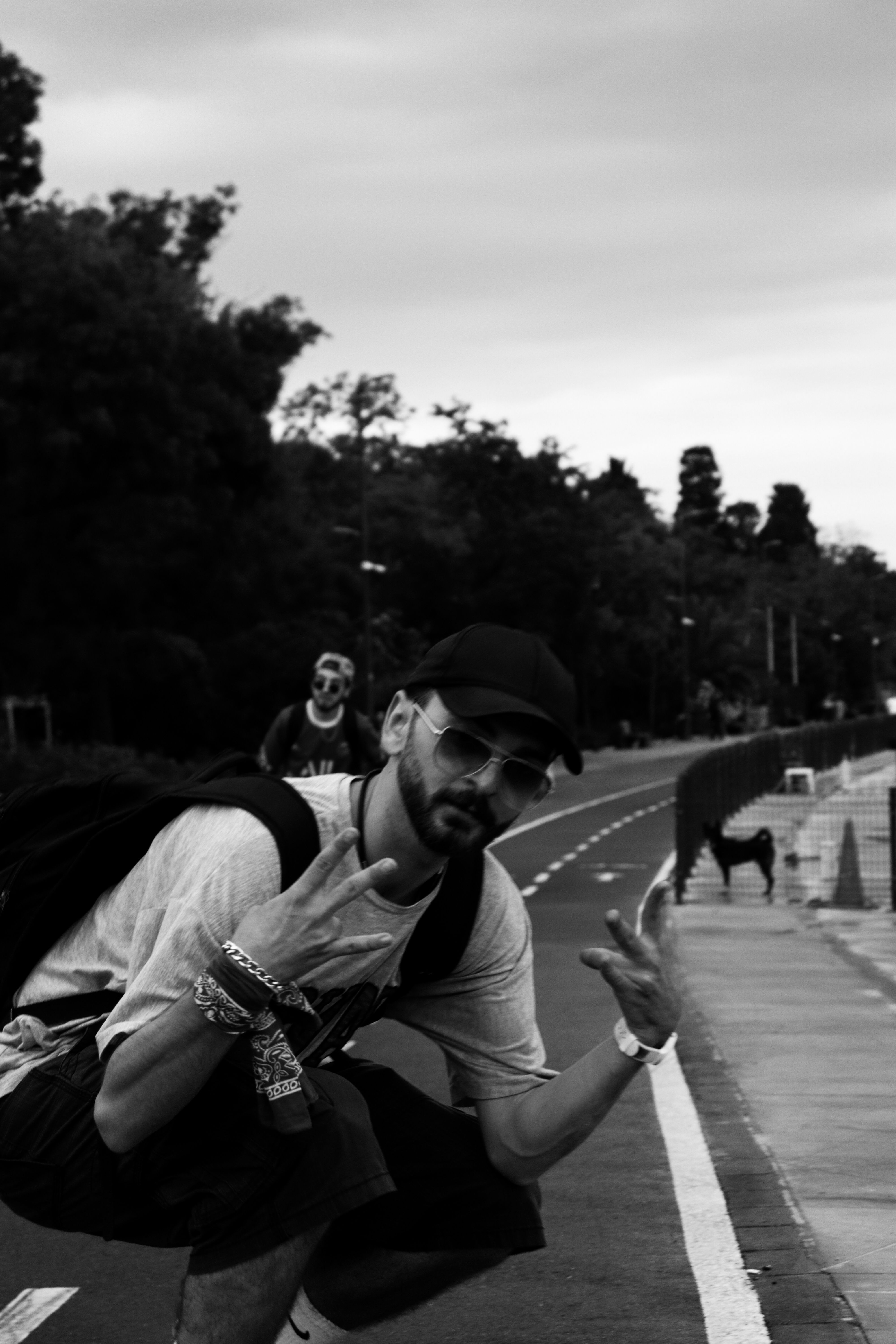 Cool street style portrait of a man posing in a black cap, featuring urban vibes.