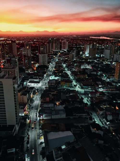 Free Stunning aerial shot of Campos dos Goytacazes, Brazil at sunset with vibrant skies and city lights. Stock Photo