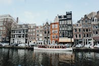 White And Brown Wooden Boat On Body Of Water