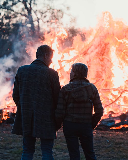 Couple standing Near a bonfire