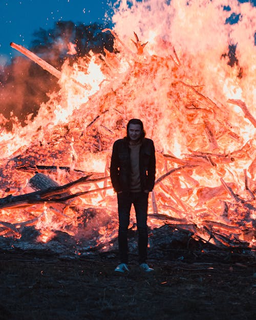 Man standing in front of a Bonfire